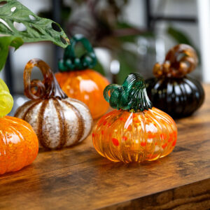Glass Pumpkins sitting on a table